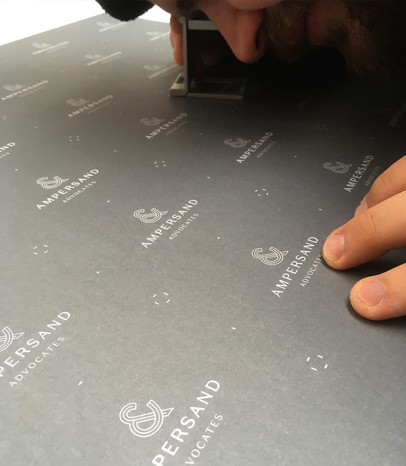 Designer checking print with a magnifying glass